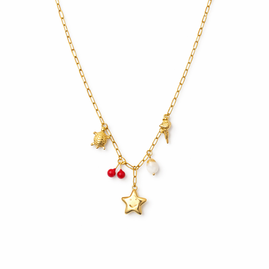 Gold necklace with star pendant, red berries, and small charms on a white background