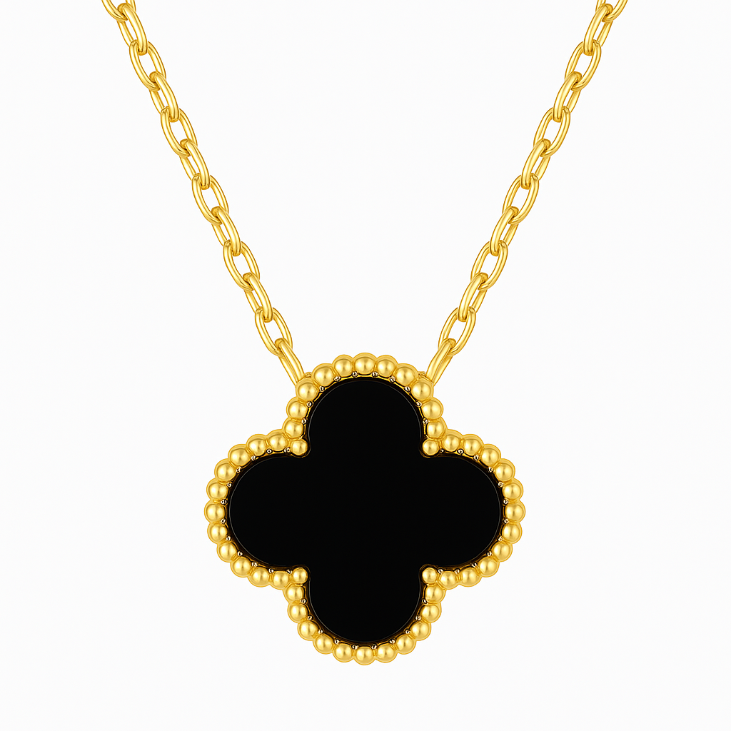 Gold necklace with a black clover-shaped pendant on a white background