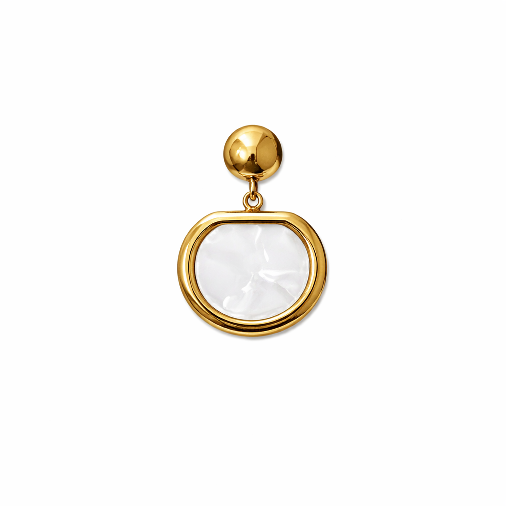 Gold pendant with a round white gemstone on a white background