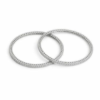 Two silver bangles on a white background
