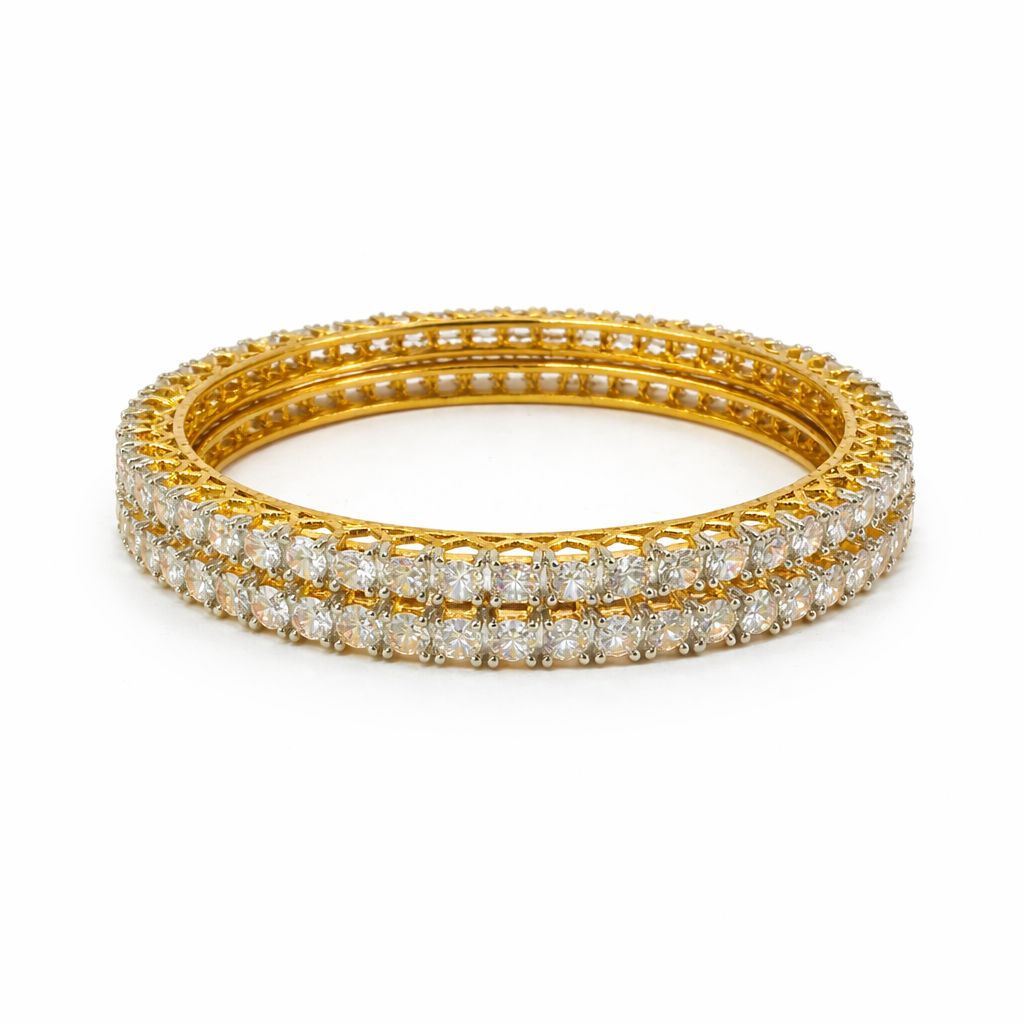 A gold-toned triple bangle bracelet set with rows of sparkling clear pavé stones, photographed on a clean white background.
