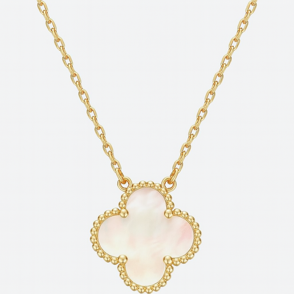 Gold necklace with a clover-shaped pendant on a light gray background