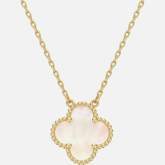 Gold necklace with a clover-shaped pendant on a light gray background