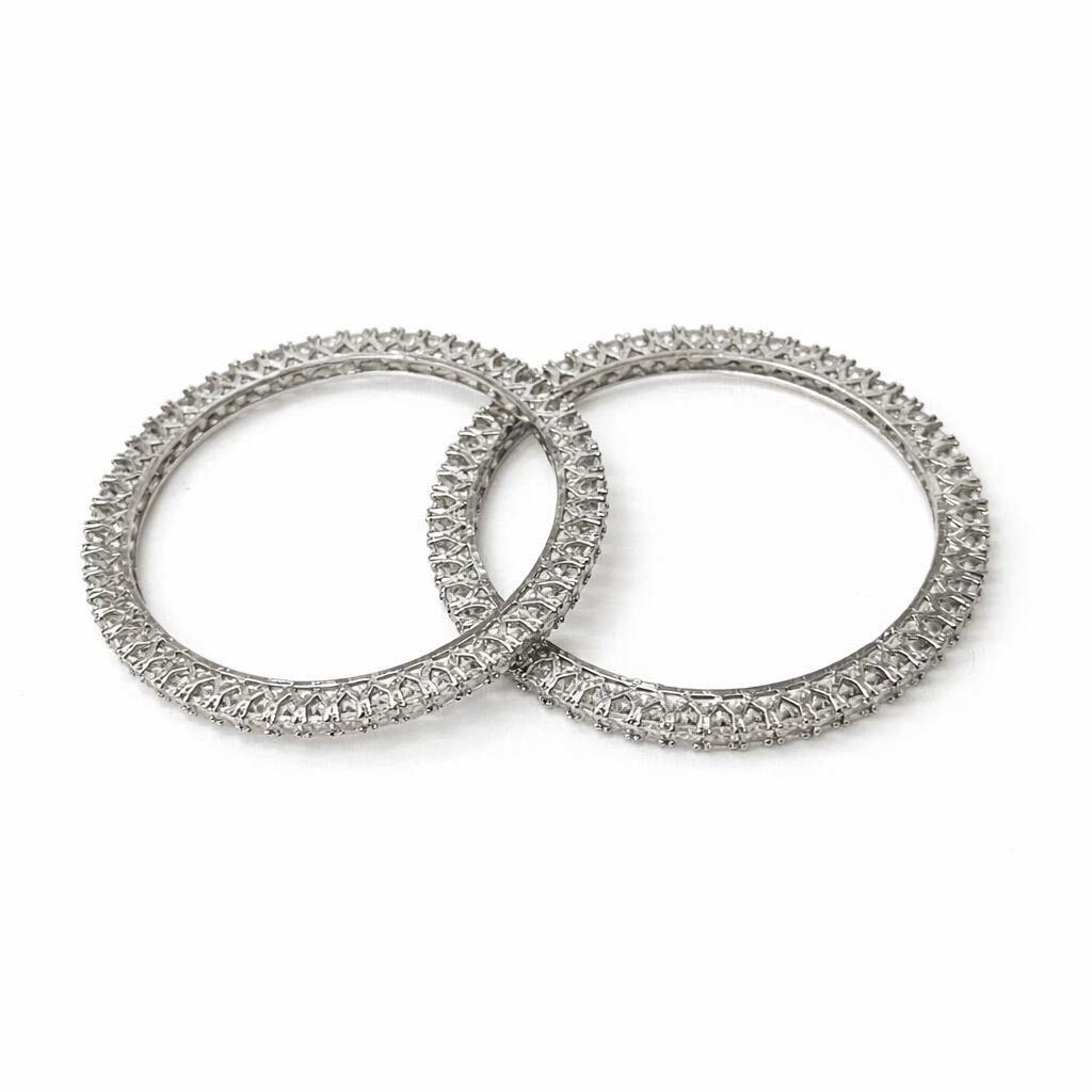 Two diamond-studded rings on a white background