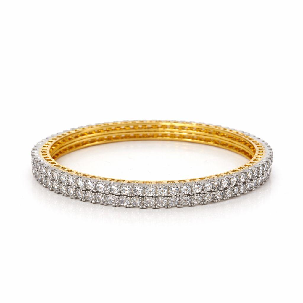 A stack of three gold bangle bracelets, with the front two rows paved with clear stones, set against a plain white background.