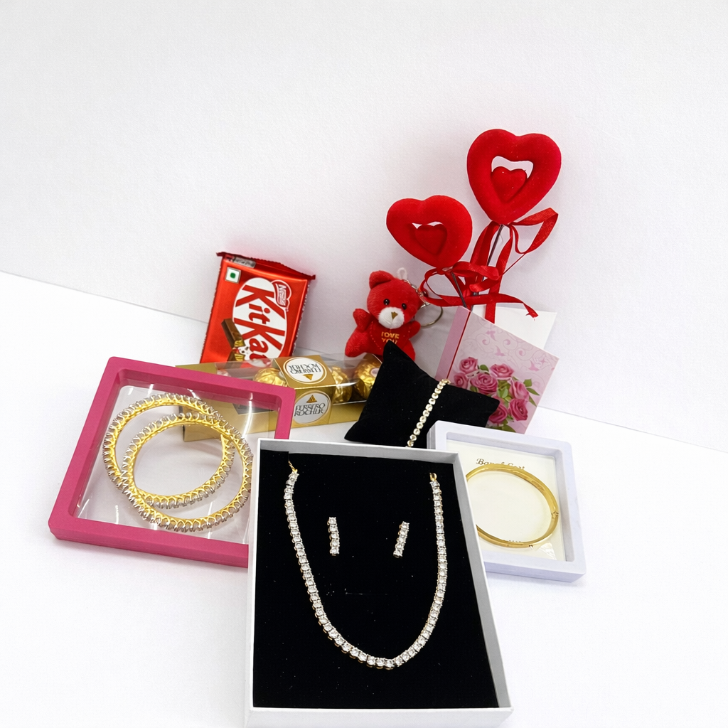 Jewelry set with gold bangles, pearl necklace, and earrings on a white background.