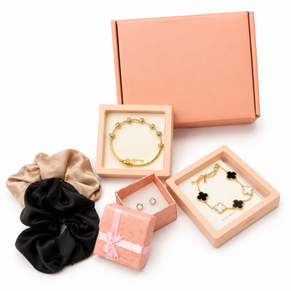 Jewelry set with scrunchies and necklaces in pink and beige boxes on a white background