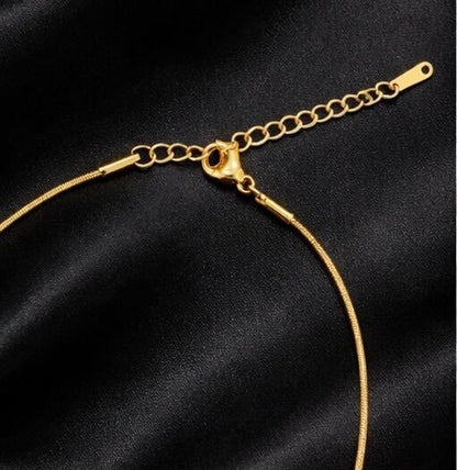 Gold necklace on a black satin background