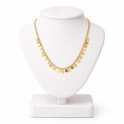 Gold necklace on a white mannequin bust with a white background