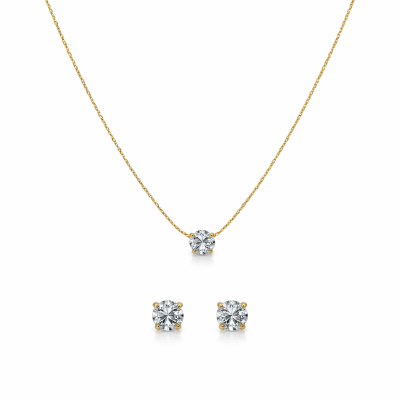 Gold necklace and earrings with clear gemstones on a white background