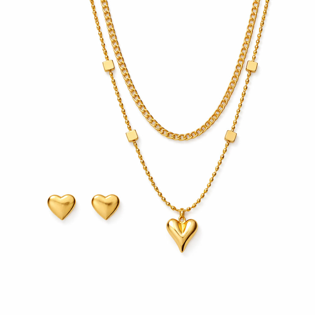 Gold heart necklace and earrings on a white background