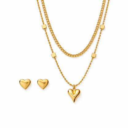 Gold heart necklace and earrings on a white background