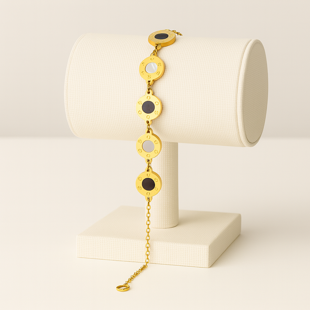 Gold bracelet with circular links on a white stand