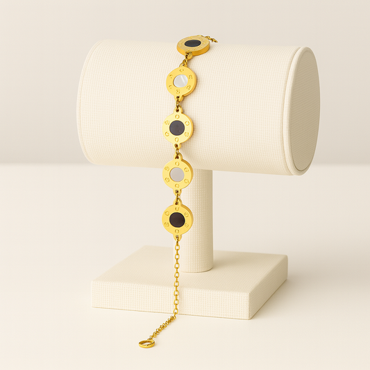Gold bracelet with circular links on a white stand