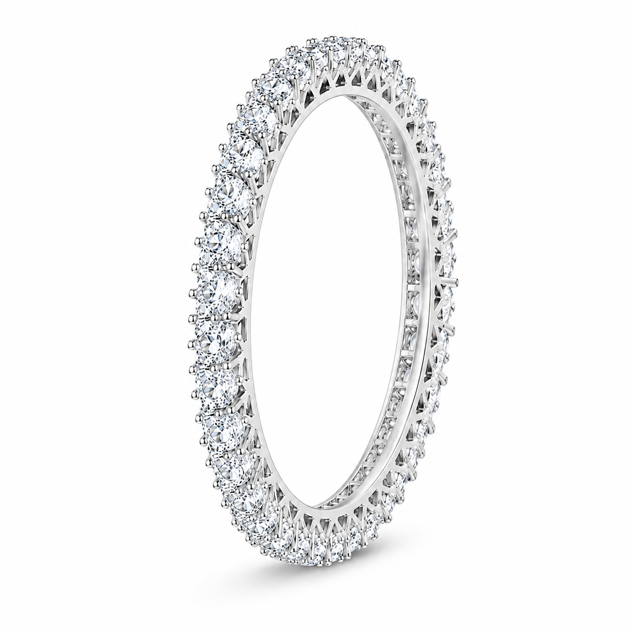 A diamond eternity ring in a polished silver-tone setting, featuring a continuous line of round-cut diamonds around the band, shown on a clean white background.