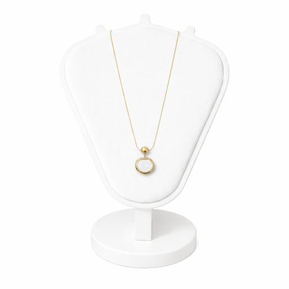 Gold necklace with a pendant on a white stand against a white background
