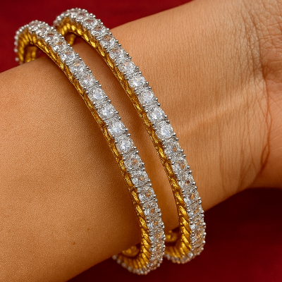 Gold and diamond bracelet on a wrist against a red background
