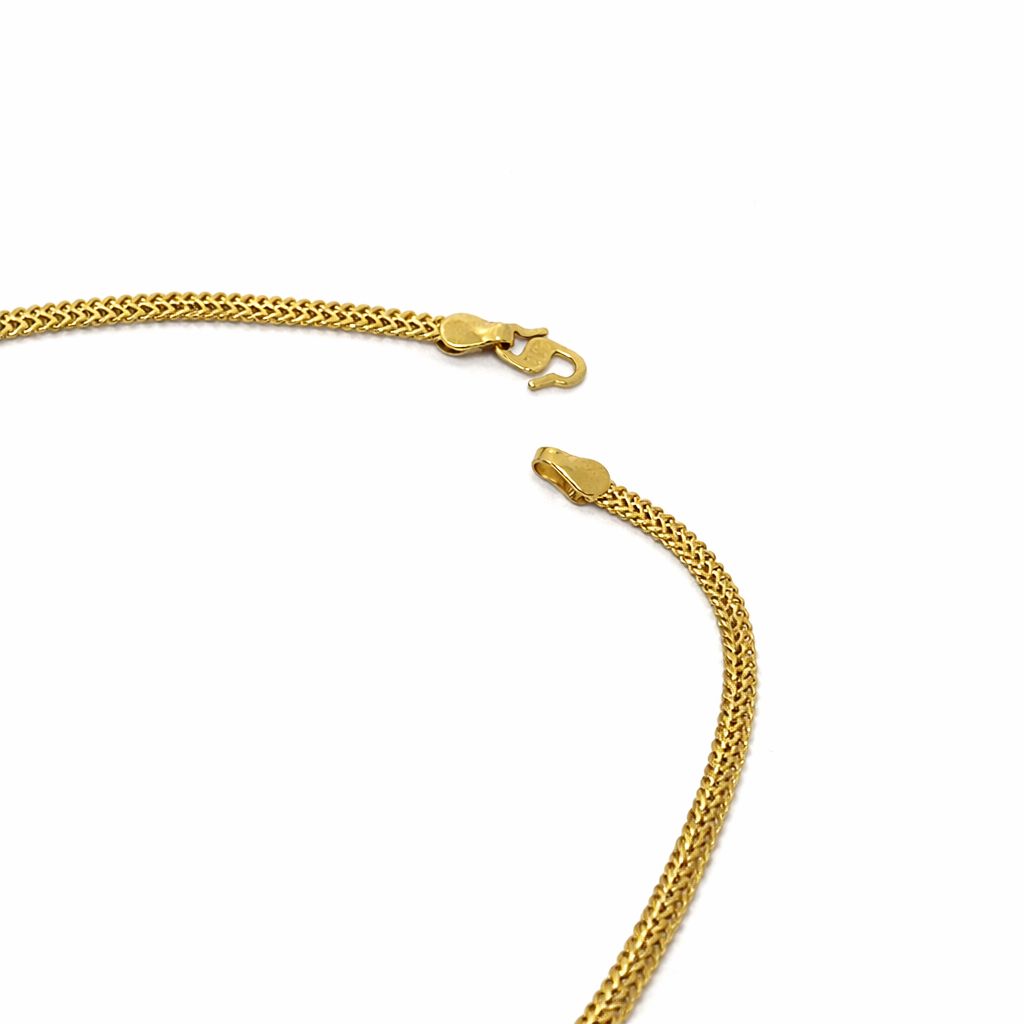 A close-up of a gold chain necklace with a lobster clasp and sliding connector, shown on a plain white background.
