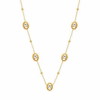 Gold necklace with diamond-like stones on a white background