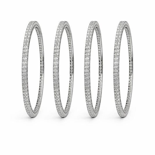 Four silver-toned eternity rings paved with small clear stones, arranged in a row on a clean white background.
