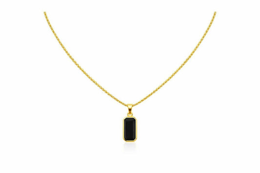 Gold necklace with a black pendant on a white background