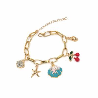 Gold bracelet with various charms on a white background