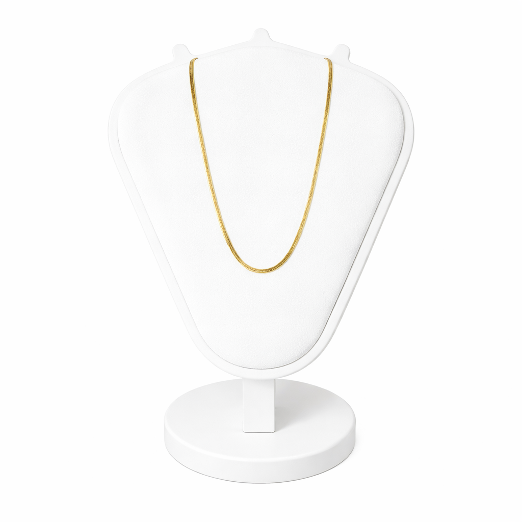 Gold necklace on a white stand with a white background