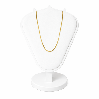 Gold necklace on a white stand with a white background