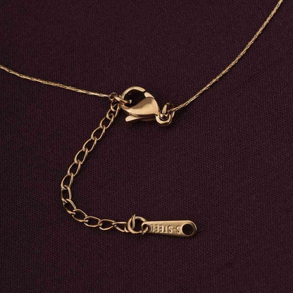Gold necklace with clasp on a dark purple background