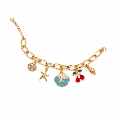 Gold bracelet with various charms on a white background