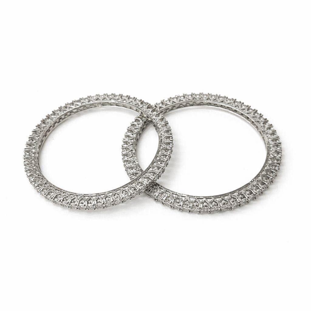 Two diamond-studded rings on a white background
