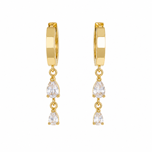 Gold hoop earrings with teardrop-shaped crystals on a white background