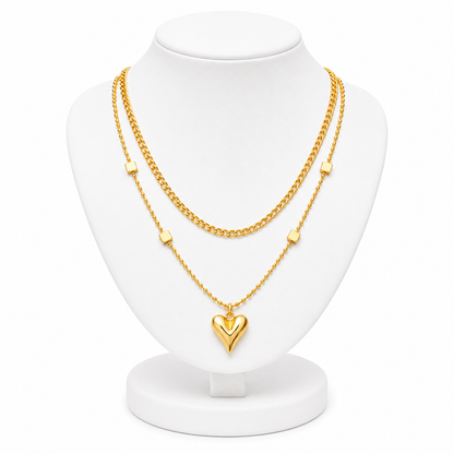 Gold necklace with a heart pendant on a white mannequin bust