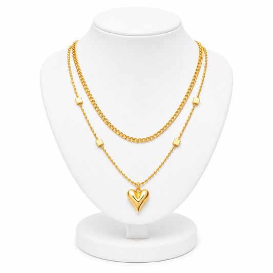 Gold necklace with a heart pendant on a white mannequin bust