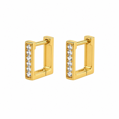 A pair of gold huggie hoop earrings with a vertical channel set with clear cubic zirconia stones, shown on a plain white background.