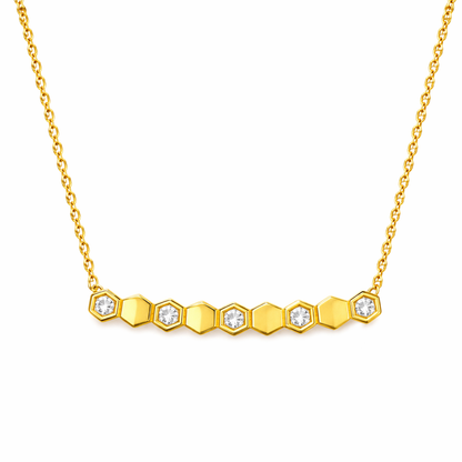 Gold necklace with hexagonal diamond pendants on a white background