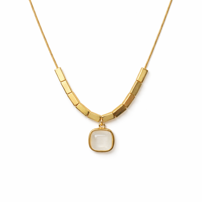 Gold necklace with a square pendant on a white background