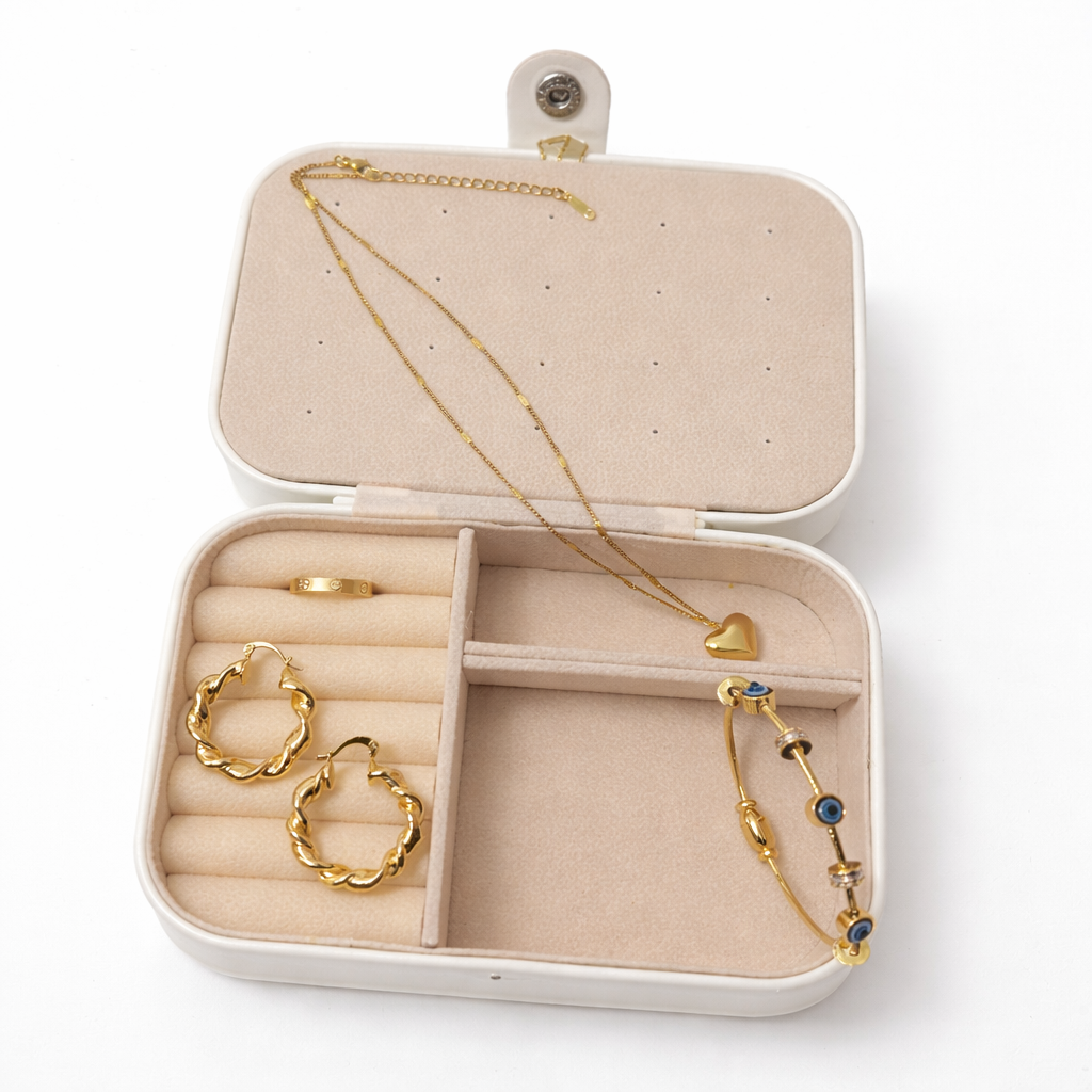 Jewelry set including a necklace, hoop earrings, and a bracelet in an open jewelry box on a white background.
