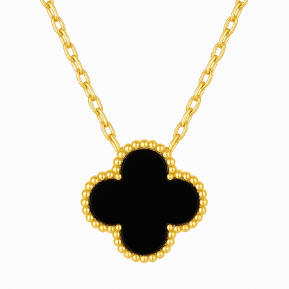 Gold necklace with a black clover-shaped pendant on a white background
