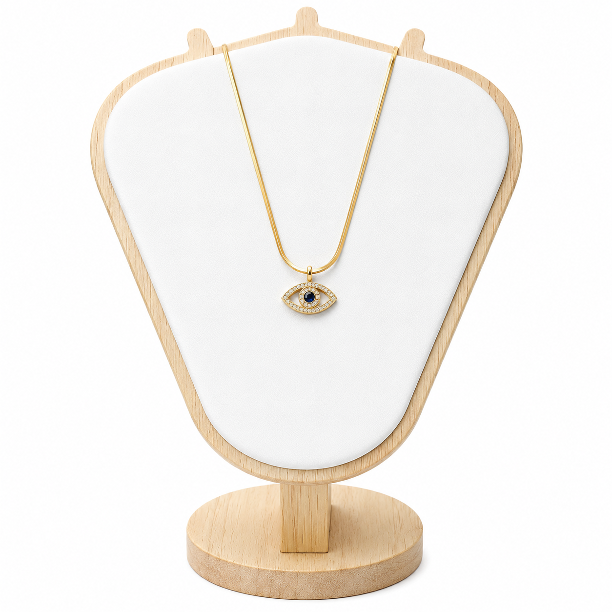 Necklace with an eye-shaped pendant on a wooden stand with a white cushion