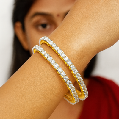 Gold and diamond bracelet on a person's wrist with a blurred background