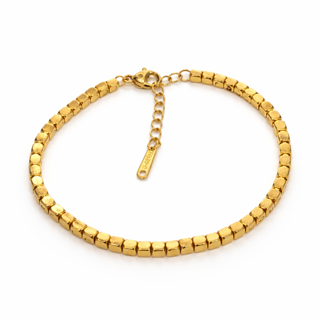 Gold beaded bracelet on a white background