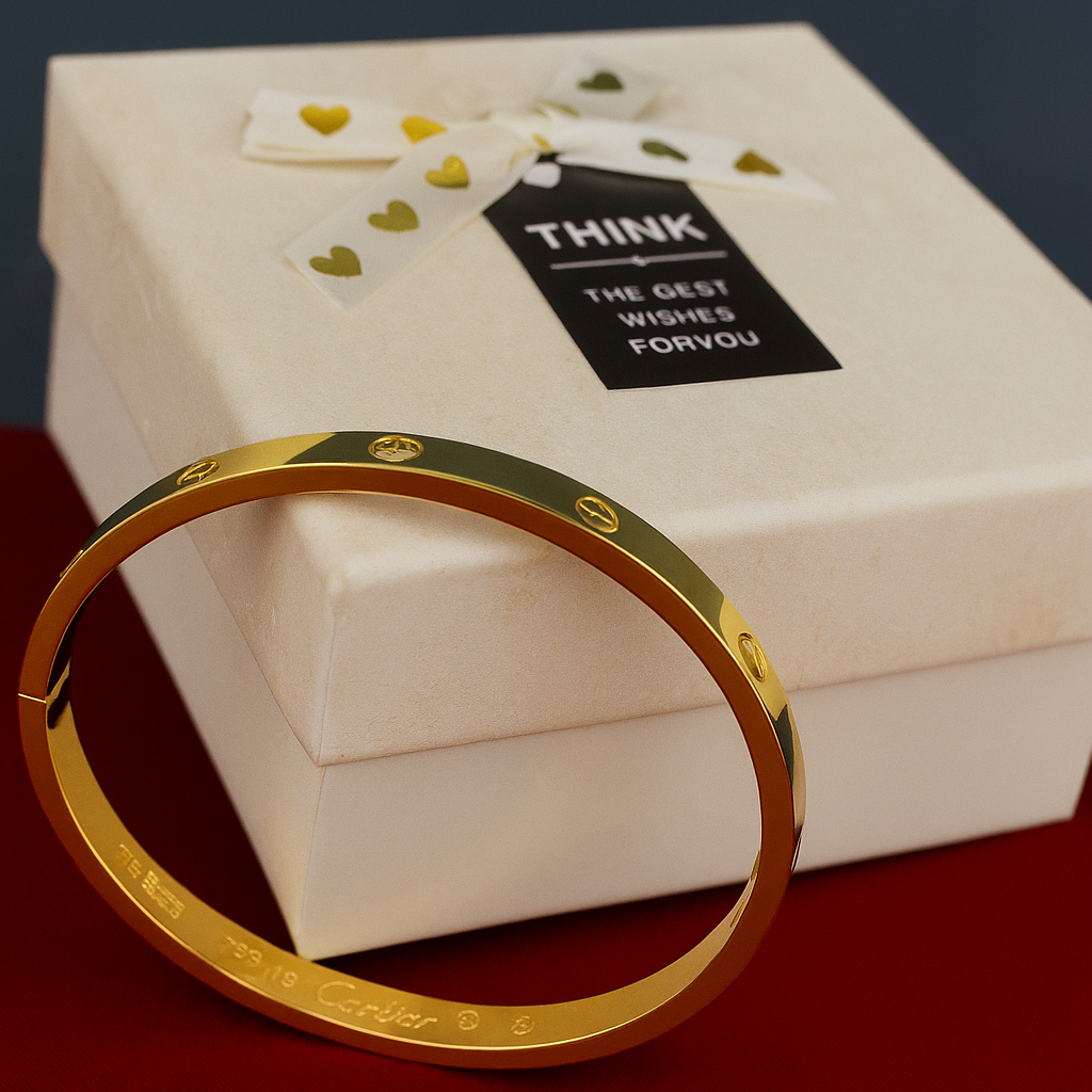 Gold bracelet on a white background with a box in the background