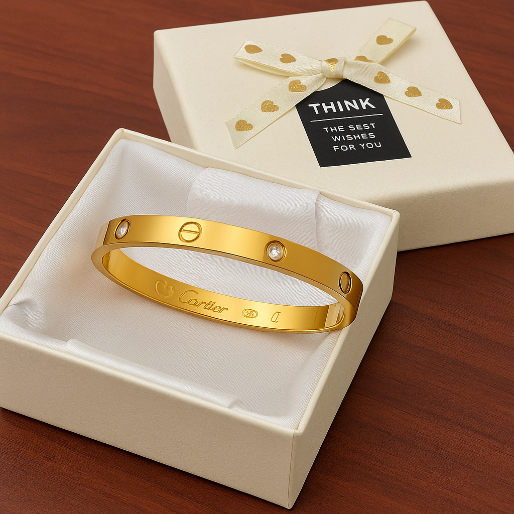 Gold bracelet in a box with a card on a white background
