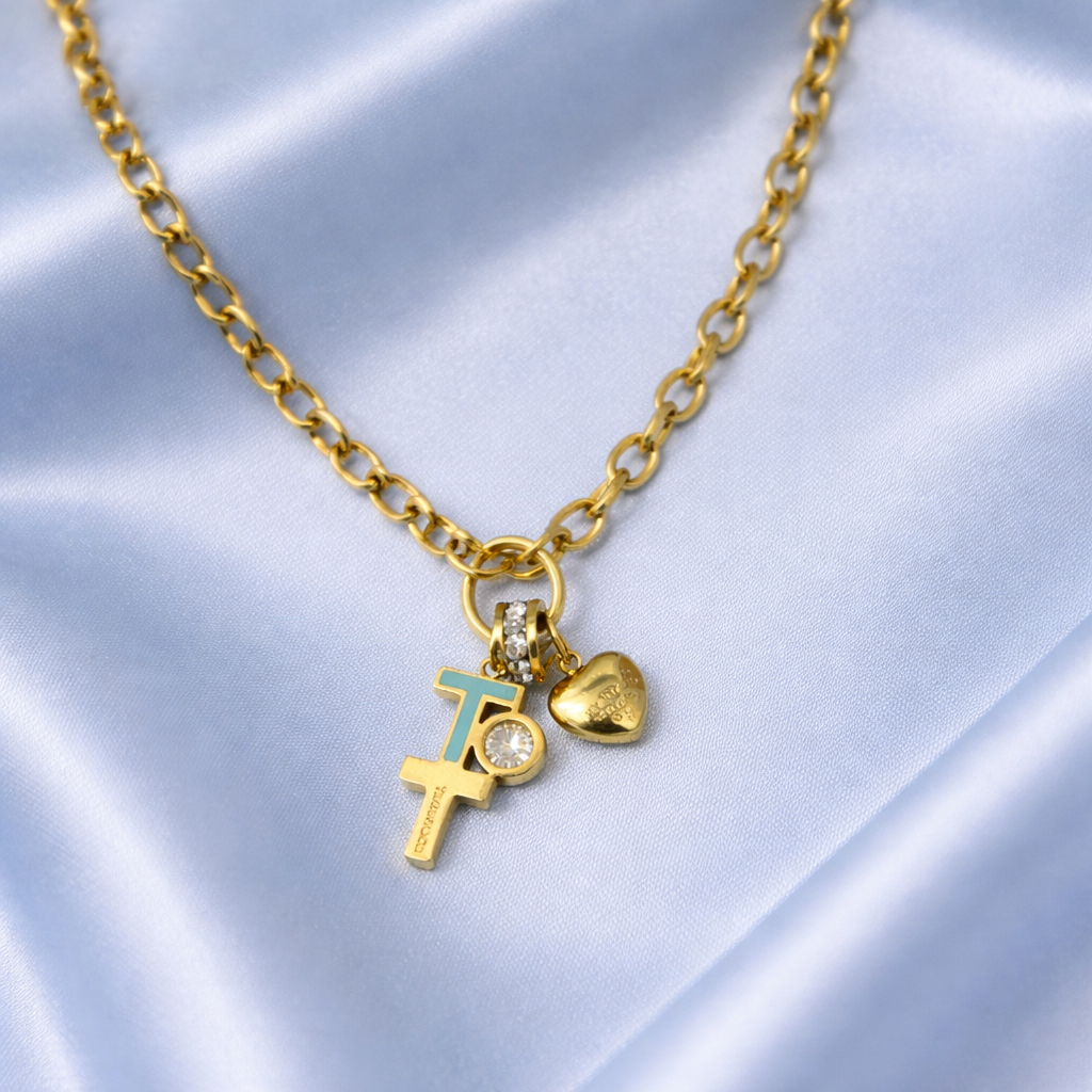 Gold necklace with charms on a light blue satin background