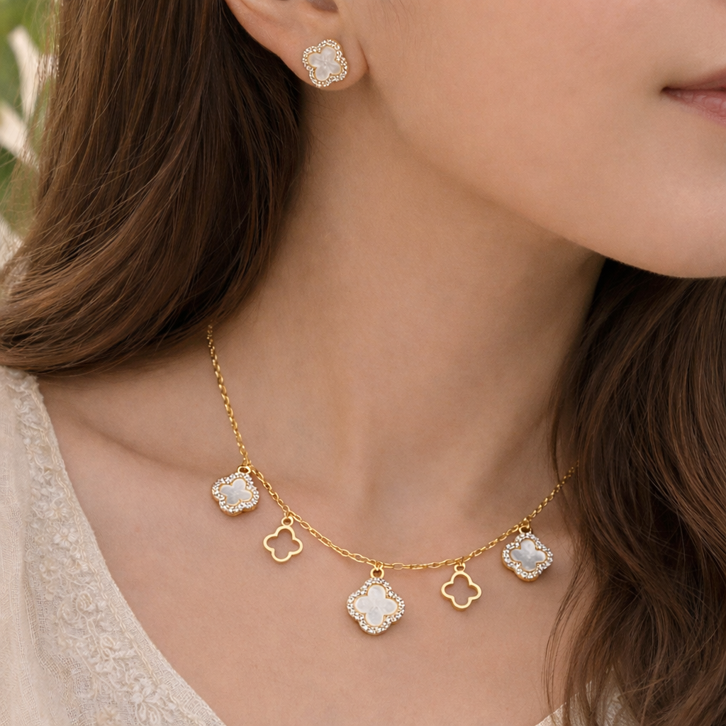 Close-up of a woman wearing a gold necklace with pendant charms.