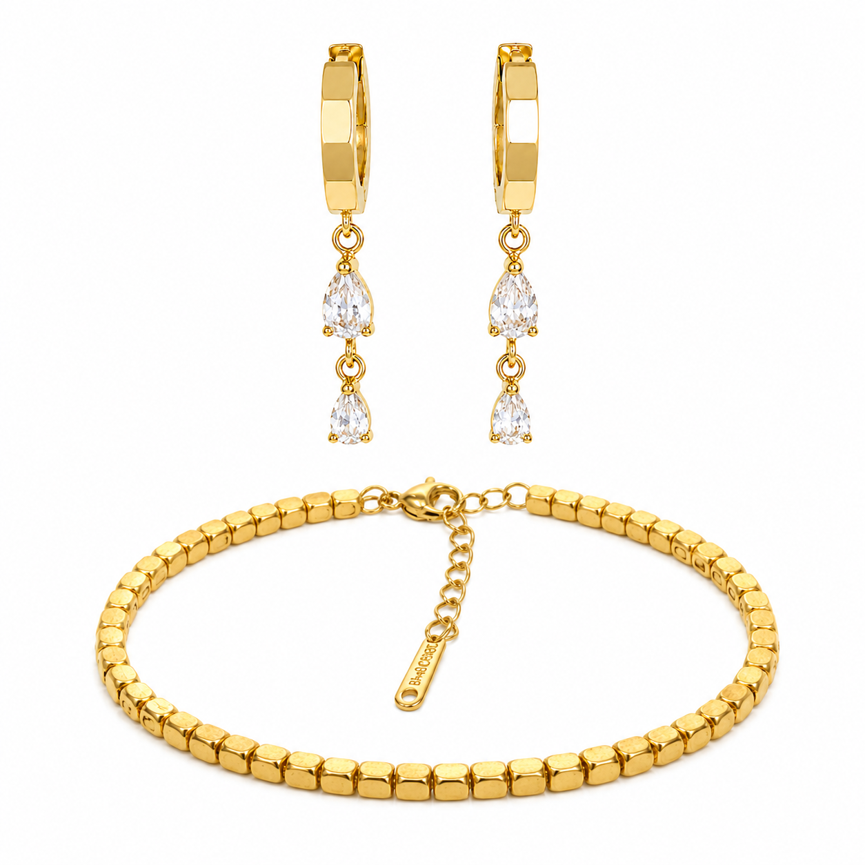 Gold bracelet and earrings set on a white background