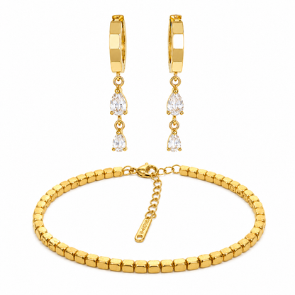 Gold bracelet and earrings set on a white background