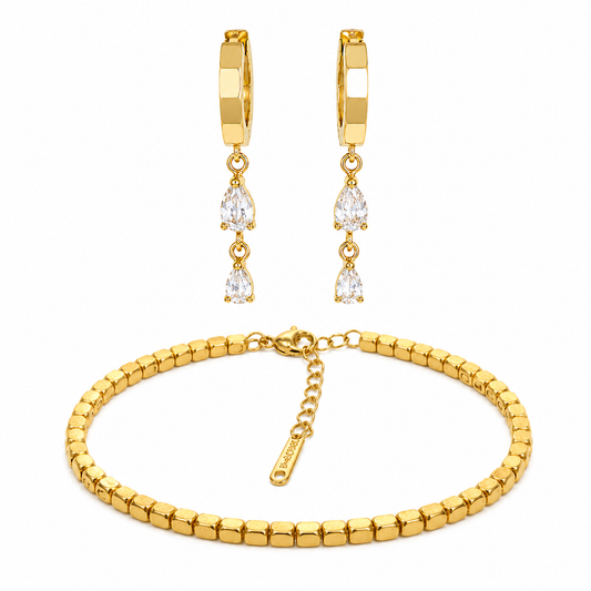Gold bracelet and earrings set on a white background