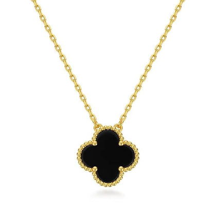 Gold necklace with a black clover pendant on a white background